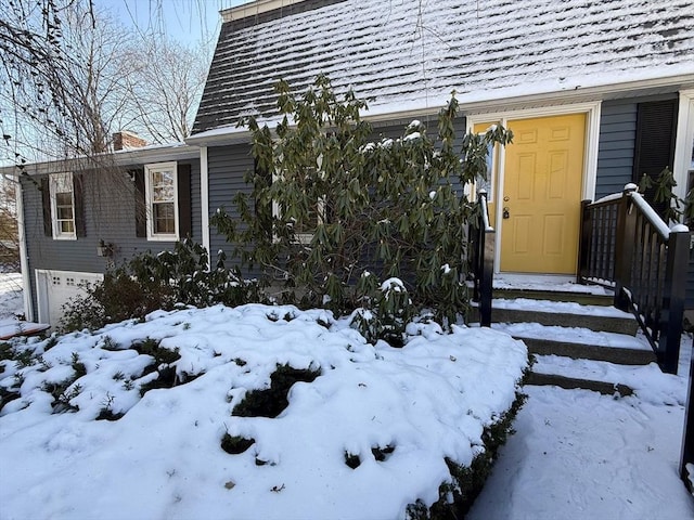 view of snow covered property entrance