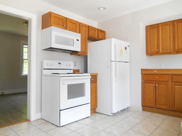 23 Trafalgar Sq Unit 23, Barre, MA 01005 - kitchen featuring white appliances, brown cabinetry, light tile patterned flooring, and light countertops