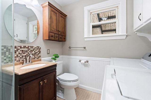 4 Rendall Pl, Melrose, MA 02176 - bathroom with vanity, wainscoting, independent washer and dryer, toilet, and tile patterned flooring