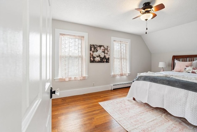 4 Rendall Pl, Melrose, MA 02176 - bedroom featuring baseboard heating, multiple windows, hardwood / wood-style flooring, baseboards, and vaulted ceiling