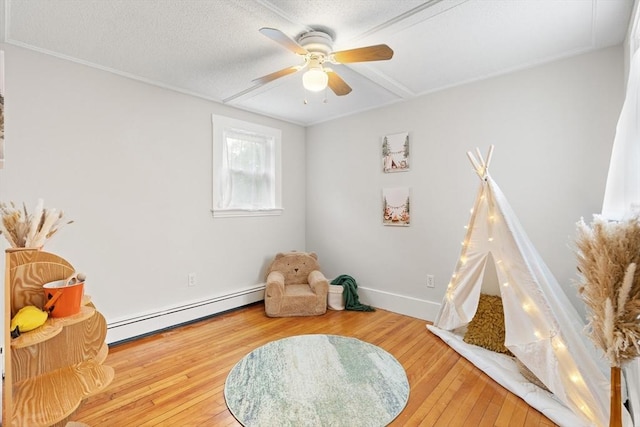 4 Rendall Pl, Melrose, MA 02176 - sitting room featuring baseboard heating, hardwood / wood-style floors, a ceiling fan, baseboards, and a textured ceiling