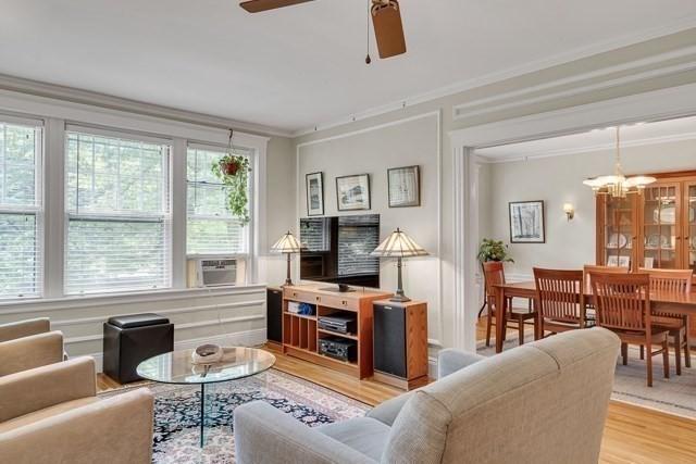 15 Thatcher St Unit F2-2, Brookline, MA 02446 - living room with light wood-type flooring, a chandelier, ornamental molding, ceiling fan, and cooling unit