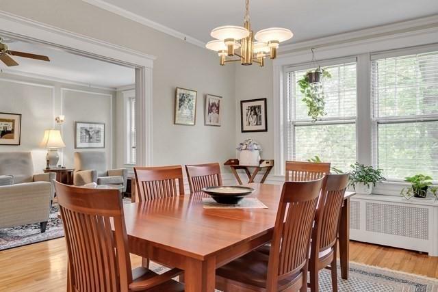15 Thatcher St Unit F2-2, Brookline, MA 02446 - dining room featuring radiator heating unit, crown molding, light wood finished floors, a chandelier, and ceiling fan