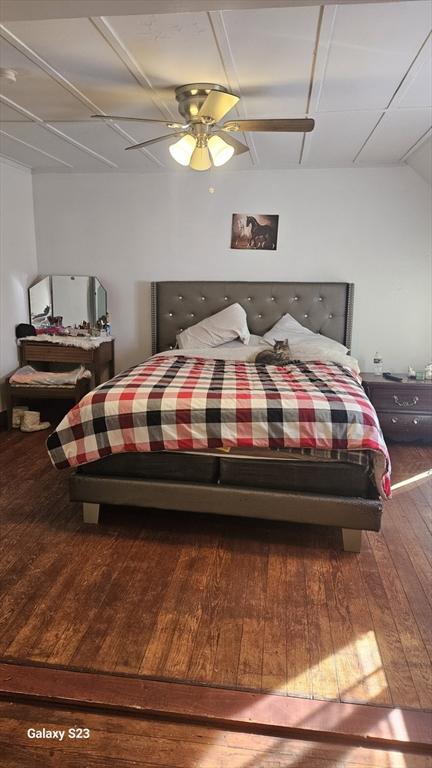 bedroom with a ceiling fan and wood-type flooring