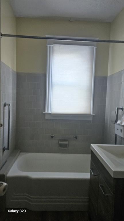 full bath with vanity, a shower, and a bathing tub