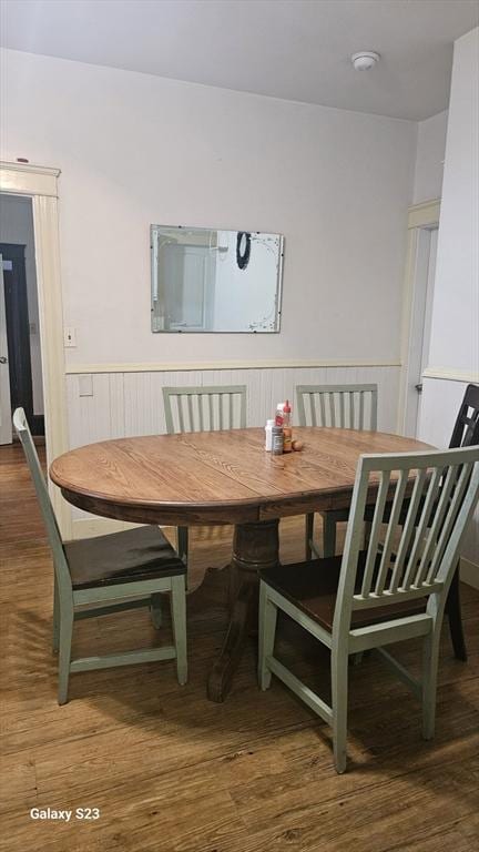 dining room with wainscoting and wood finished floors