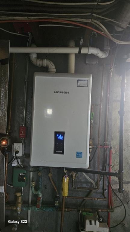 utility room with tankless water heater