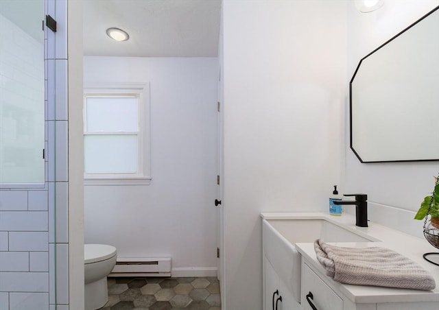 bathroom with vanity, baseboard heating, and toilet