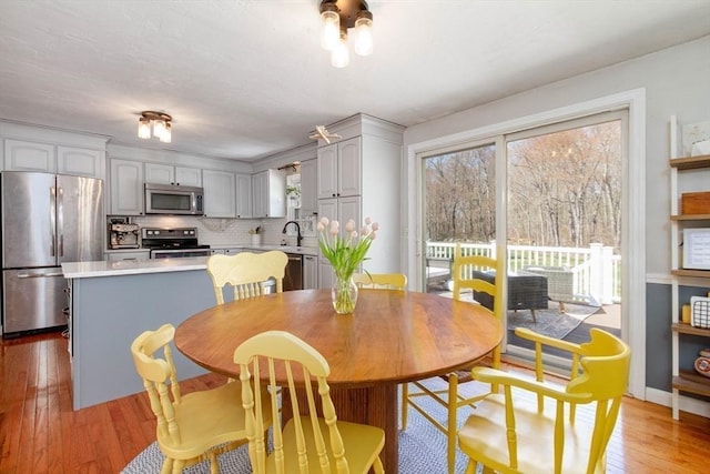dining area featuring light wood-type flooring