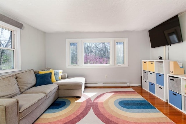 living area with baseboard heating and wood finished floors