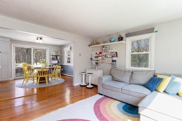living area with light wood-type flooring and a baseboard radiator