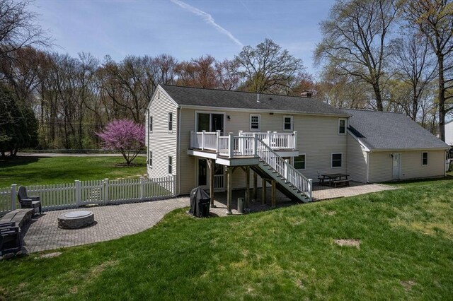 rear view of house featuring fence, a deck, stairs, a patio area, and an outdoor fire pit