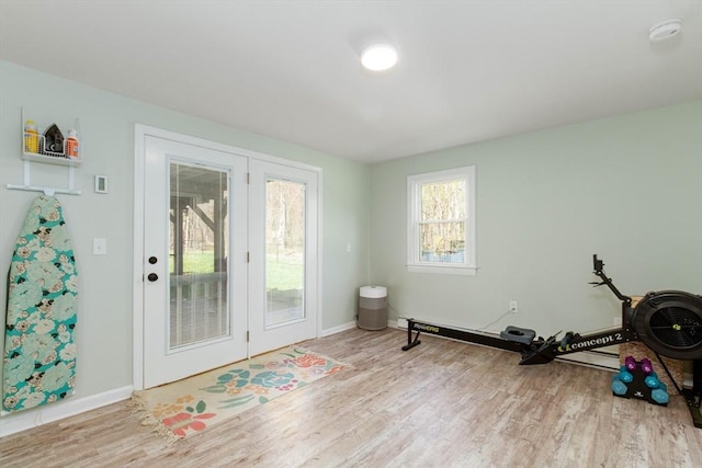 interior space with baseboards and wood finished floors