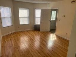 unfurnished room with hardwood / wood-style floors