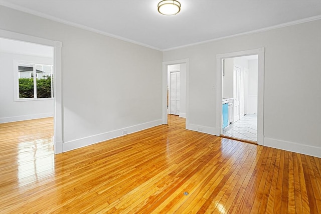 1 Melville St, Worcester, MA 01605 - spare room featuring light wood-style floors, crown molding, and baseboards