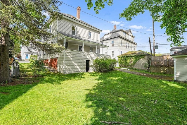1 Melville St, Worcester, MA 01605 - rear view of house with a lawn and a chimney