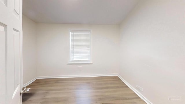 spare room with hardwood / wood-style floors