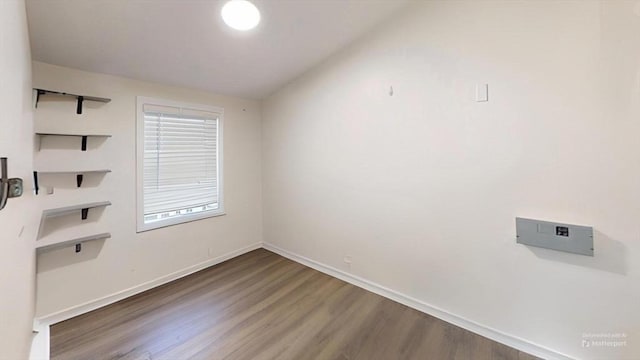 spare room with dark wood-type flooring