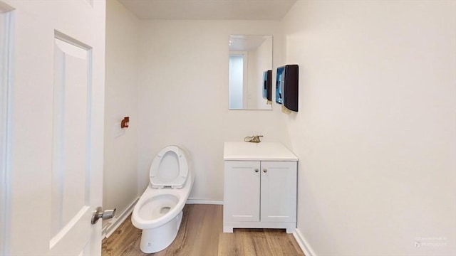 bathroom featuring sink, hardwood / wood-style floors, and toilet