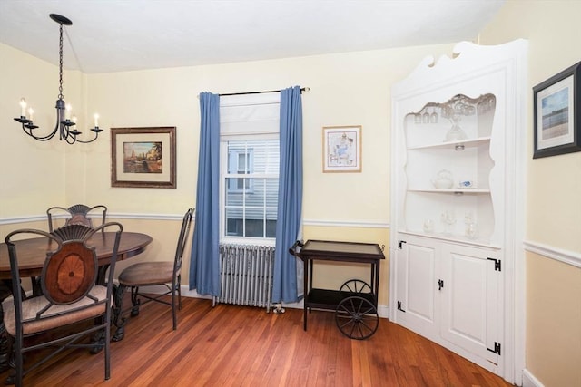 249 E Squantum St Unit 2, Quincy, MA 02171 - dining space with radiator, a chandelier, and wood finished floors