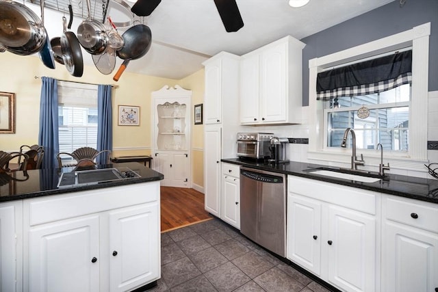 249 E Squantum St Unit 2, Quincy, MA 02171 - kitchen with dishwasher, white cabinetry, dark tile patterned floors, decorative backsplash, and a ceiling fan