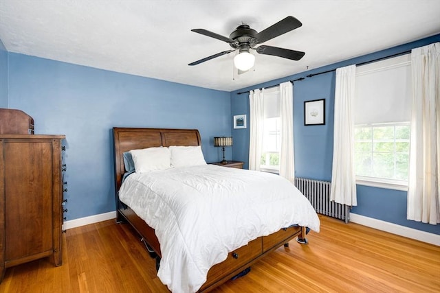 249 E Squantum St Unit 2, Quincy, MA 02171 - bedroom with radiator, wood finished floors, and ceiling fan