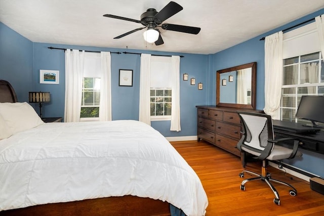 249 E Squantum St Unit 2, Quincy, MA 02171 - bedroom featuring wood finished floors, multiple windows, a ceiling fan, and a desk