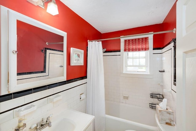 249 E Squantum St Unit 2, Quincy, MA 02171 - bathroom with shower / tub combo, tile walls, and vanity