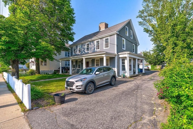 249 E Squantum St Unit 2, Quincy, MA 02171 - view of front of home with a chimney, driveway, and a porch