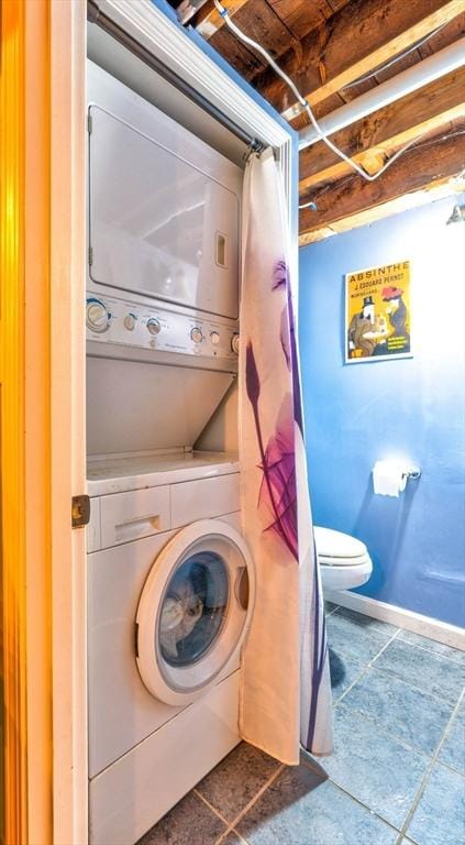 249 E Squantum St Unit 2, Quincy, MA 02171 - laundry area with stacked washer and clothes dryer and tile patterned flooring