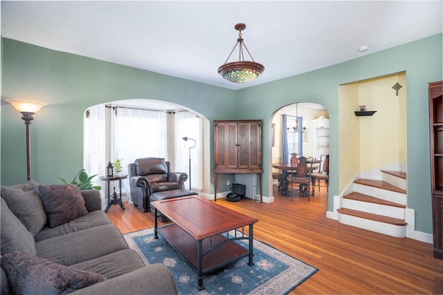 249 E Squantum St Unit 2, Quincy, MA 02171 - living room featuring arched walkways, light wood finished floors, and stairway