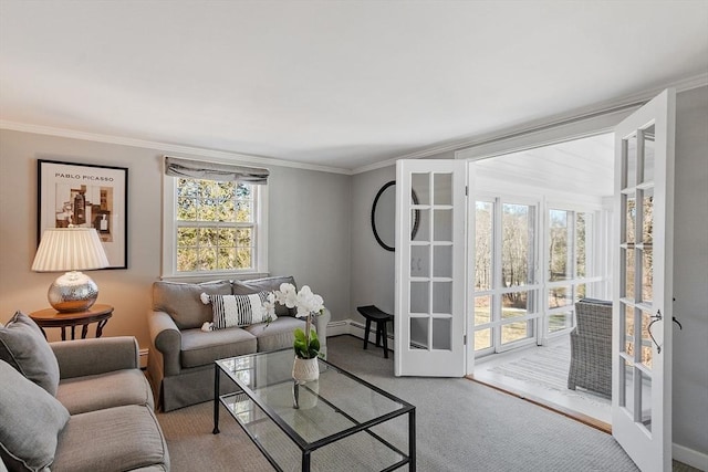 living area with carpet flooring, a baseboard radiator, a baseboard heating unit, and ornamental molding