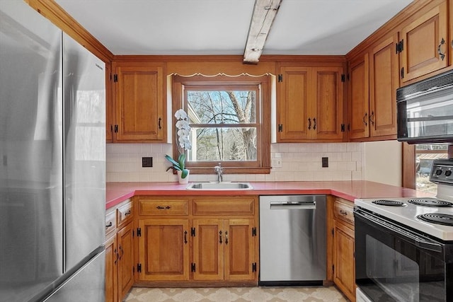 kitchen with decorative backsplash, brown cabinets, stainless steel appliances, and a sink