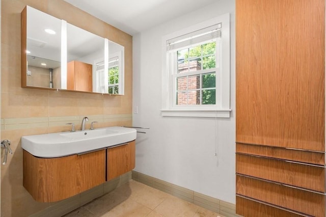 bathroom featuring baseboards, tasteful backsplash, vanity, and tile patterned floors