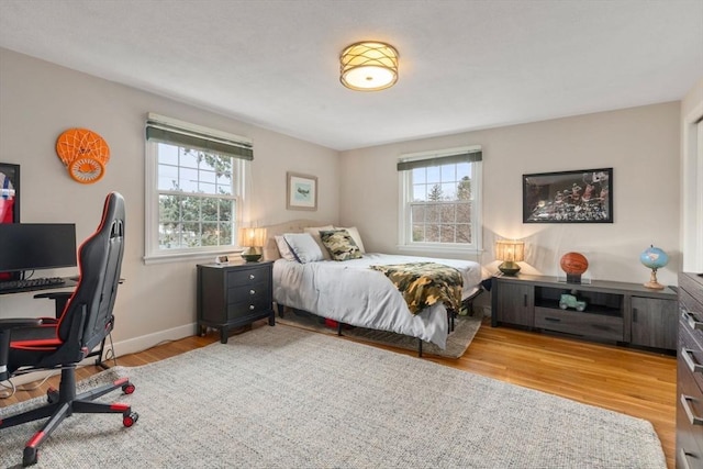 bedroom with wood finished floors and baseboards