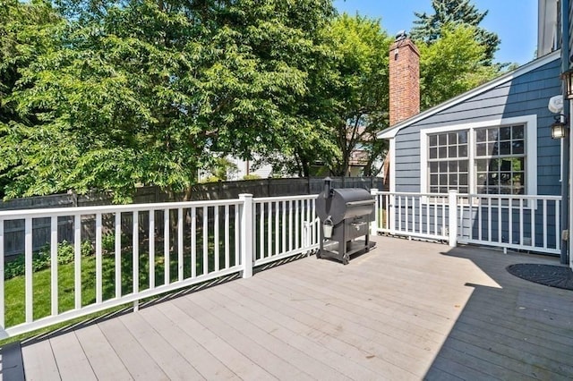 wooden deck featuring grilling area and a fenced backyard