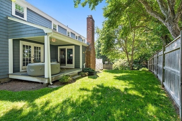 view of yard featuring french doors and a fenced backyard