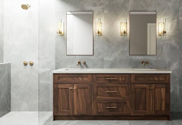 bathroom featuring dual sinks, oversized vanity, and tile walls