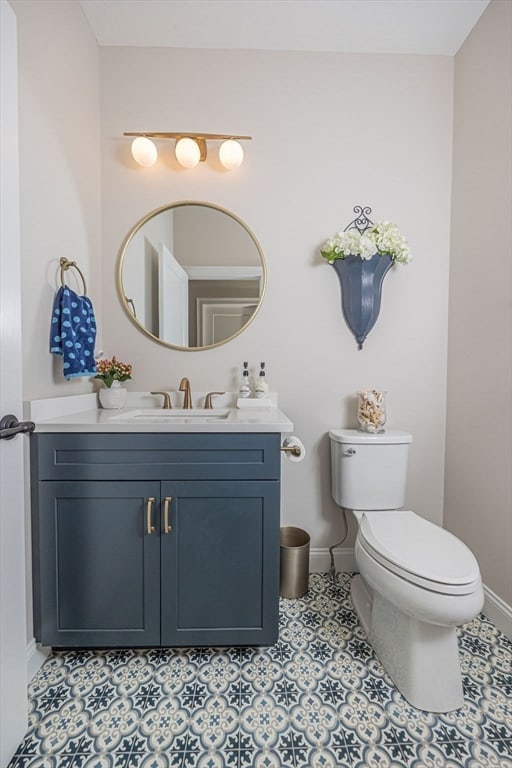 bathroom with vanity, tile patterned flooring, and toilet