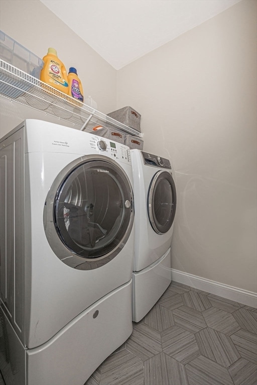 clothes washing area featuring independent washer and dryer