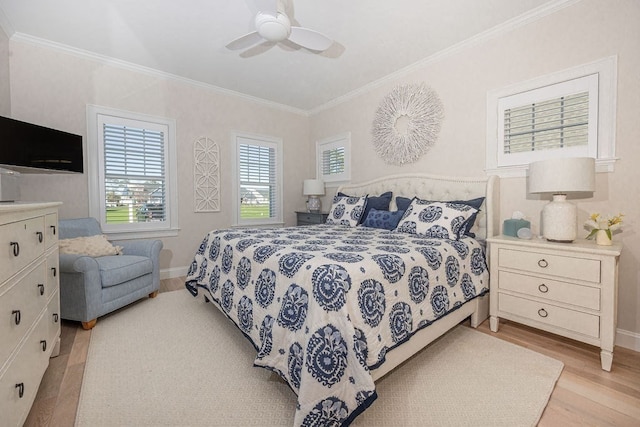 bedroom with ceiling fan, light hardwood / wood-style flooring, and crown molding