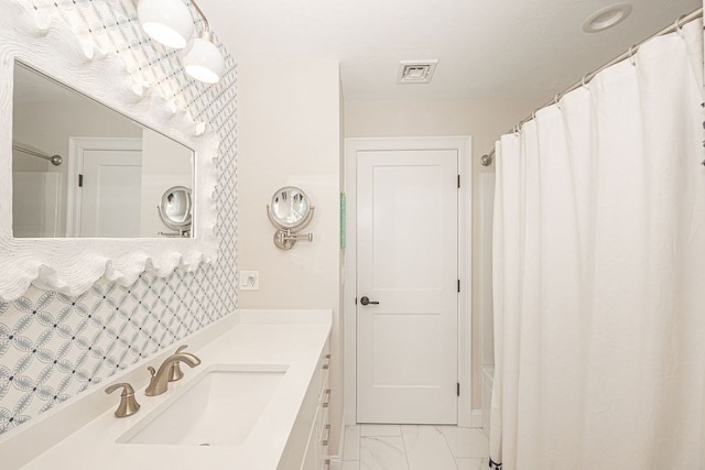 bathroom featuring vanity and a shower with shower curtain