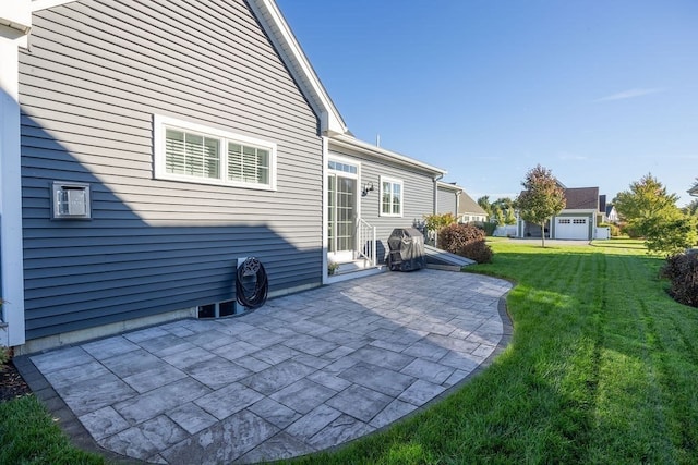 rear view of house with a garage, a yard, and a patio area