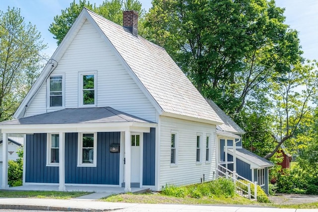 243 Bridge St, Northampton, MA 01060 - view of front of home with a chimney, board and batten siding, and a porch