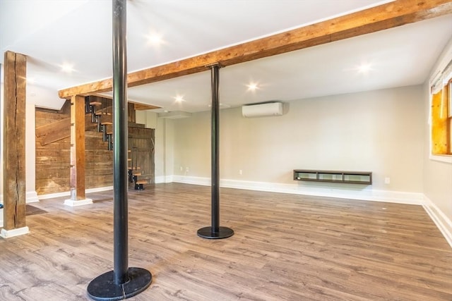 243 Bridge St, Northampton, MA 01060 - finished basement with a wall unit AC, wood finished floors, stairs, baseboards, and wood walls