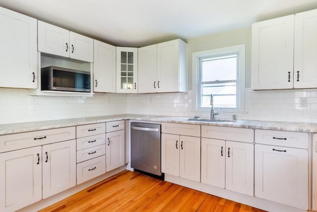 243 Bridge St, Northampton, MA 01060 - kitchen with appliances with stainless steel finishes, a sink, light wood-style floors, and white cabinets