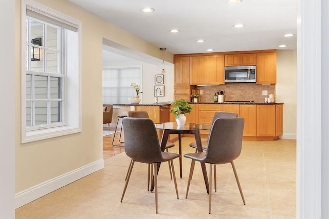 tiled dining area featuring sink