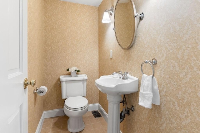 bathroom featuring tile patterned flooring and toilet