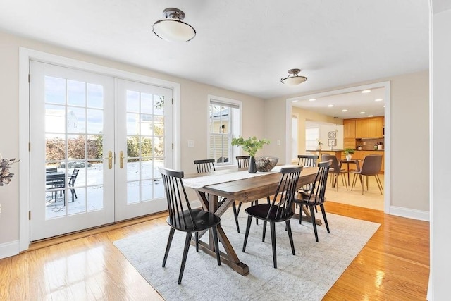 dining room featuring light wood-type flooring and french doors