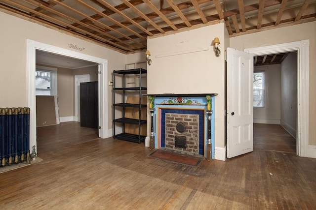 unfurnished living room with dark hardwood / wood-style flooring